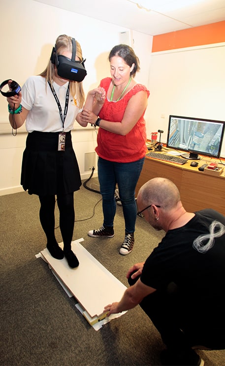 Woman using VR headset playing a walk the plank game